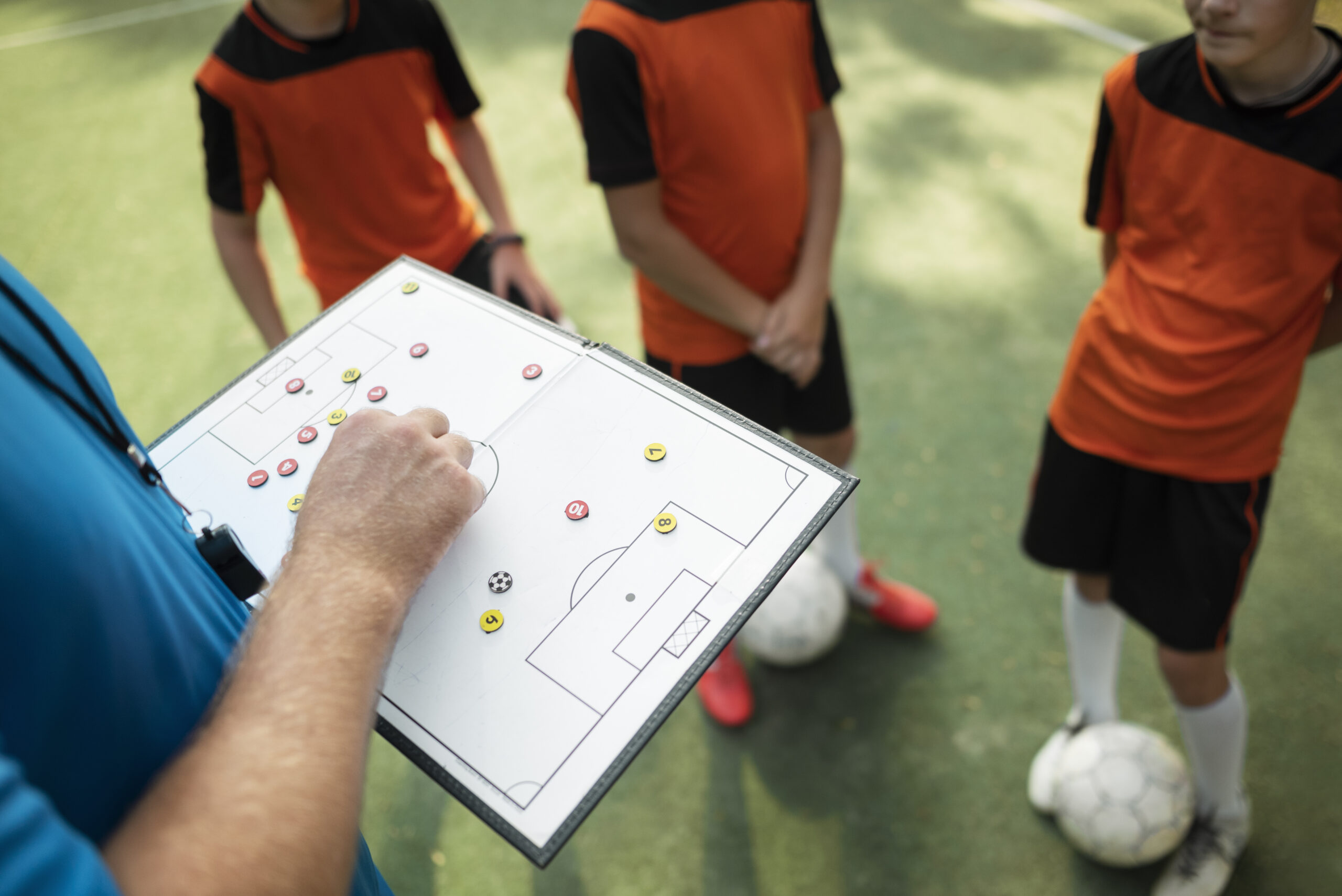 Football Trainer hand in a Pocket